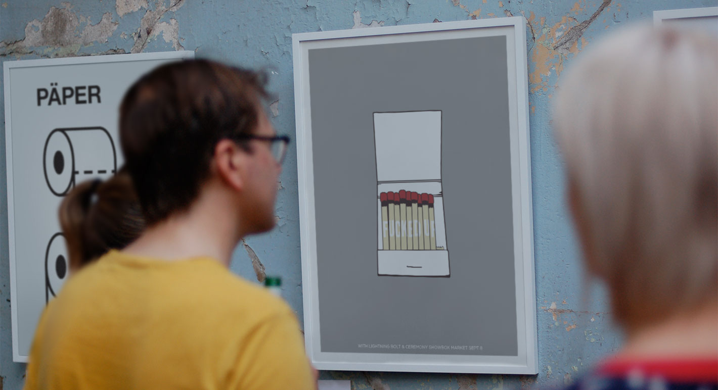 Gallery visitors viewing prints on weathered blue wall at 112 PrintWorks