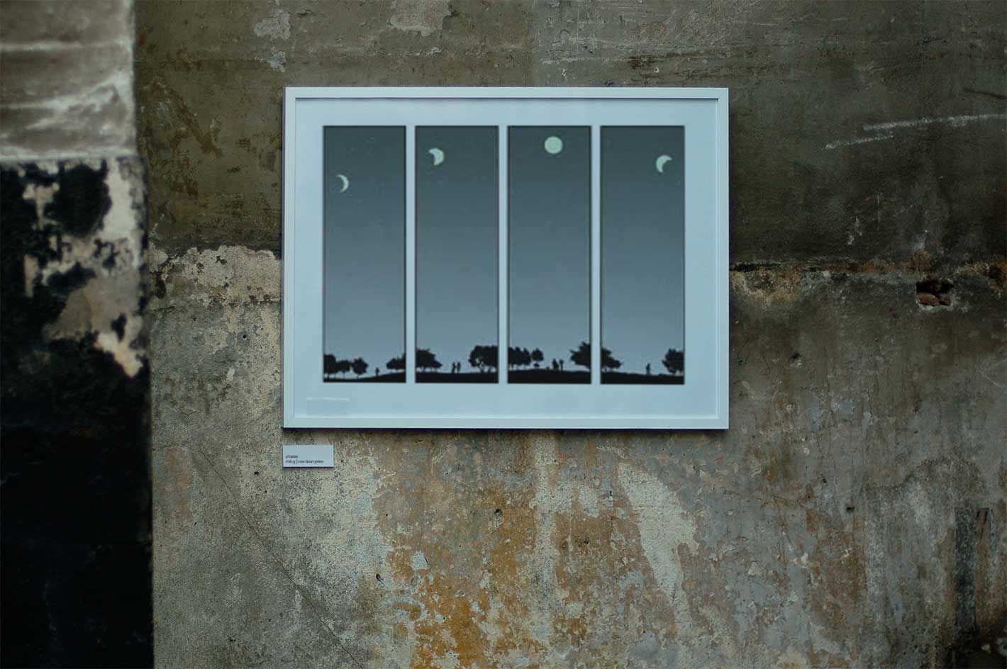 Moon phases print in white frame on weathered concrete wall