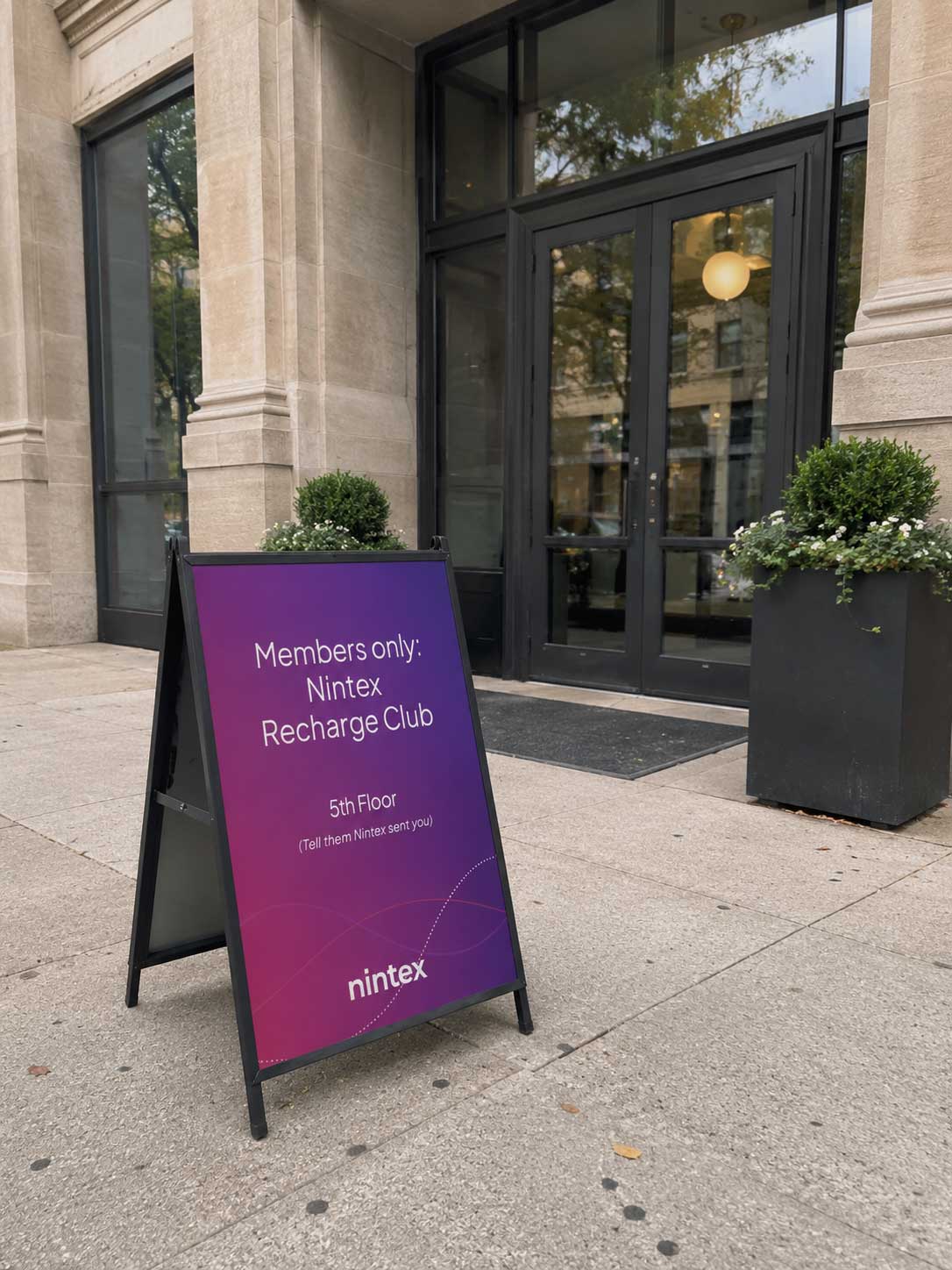 Nintex Recharge Club A-board outside the building